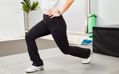 Person stretching while wearing Yogipace Bootcut Yoga Pants