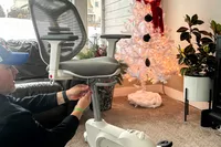 A close-up of a person assembling the Flexispot Deskbike V6 Pro