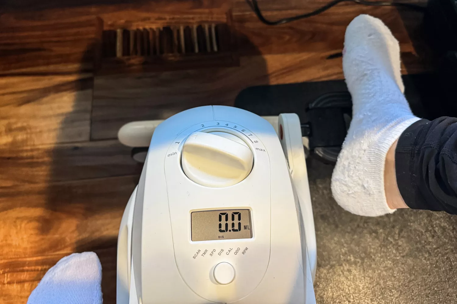An overhead close-up of a person pedaling the Flexispot Deskbike V6 Pro