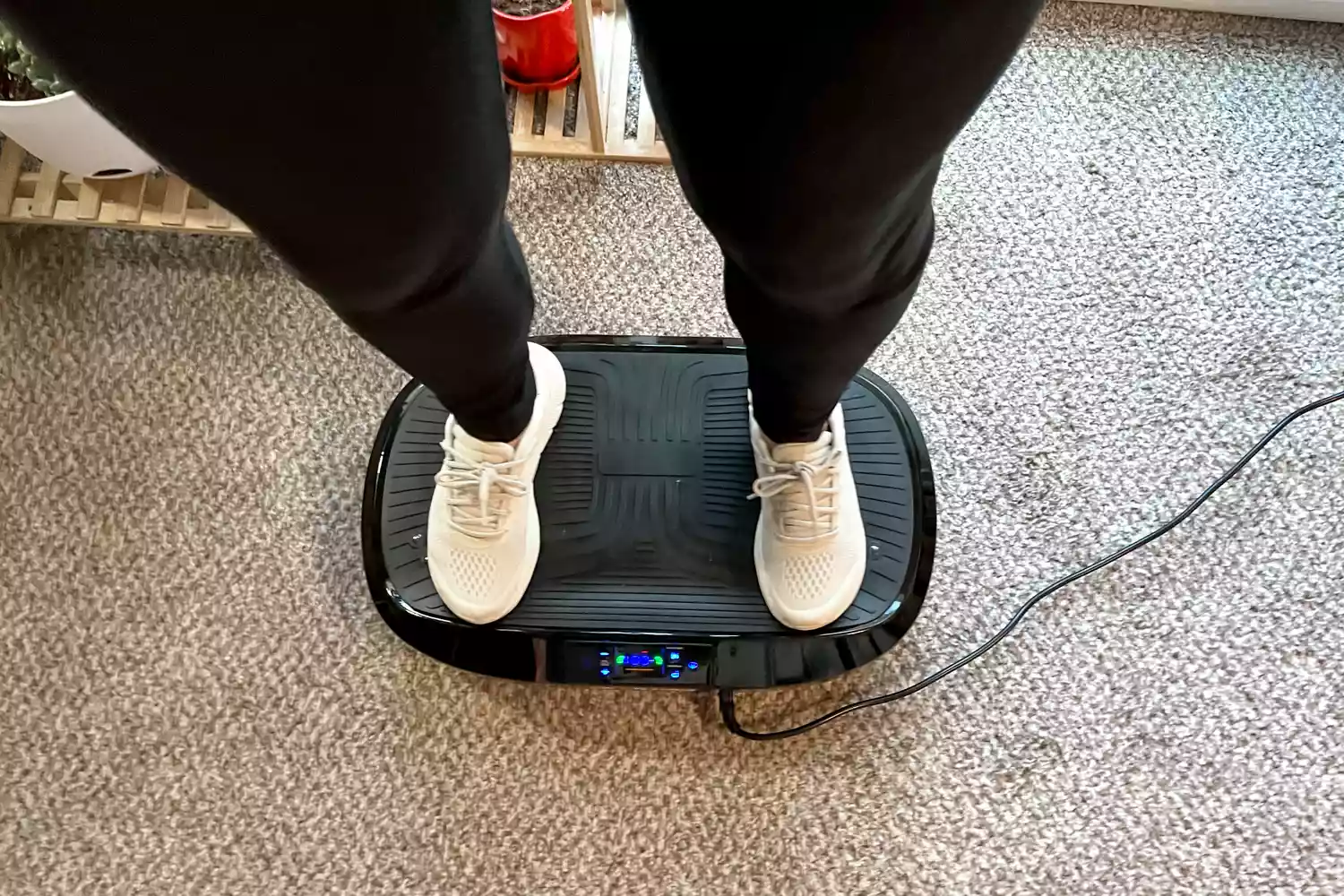 An overhead view of a person standing on the Flybird Mini Vibration Plate