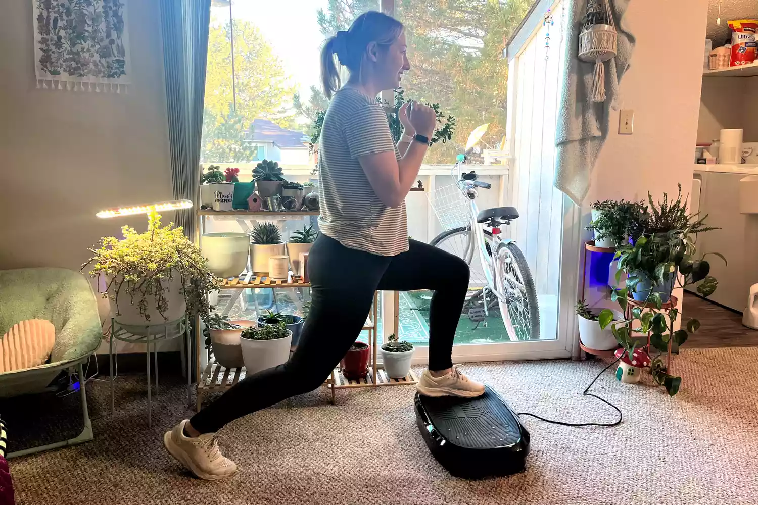 A person does lunges on the Flybird Mini Vibration Plate