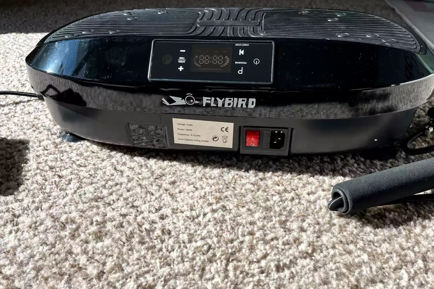 The logo and power button on the Flybird Mini Vibration Plate