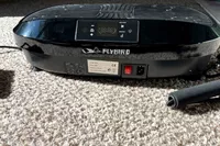 The logo and power button on the Flybird Mini Vibration Plate