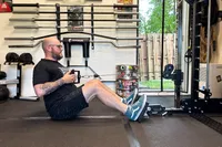 A person executes pull-ups on the Force USA G20 Pro All-In-One Trainer