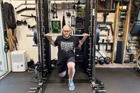 A person lifts weight on the Force USA G20 Pro All-In-One Trainer