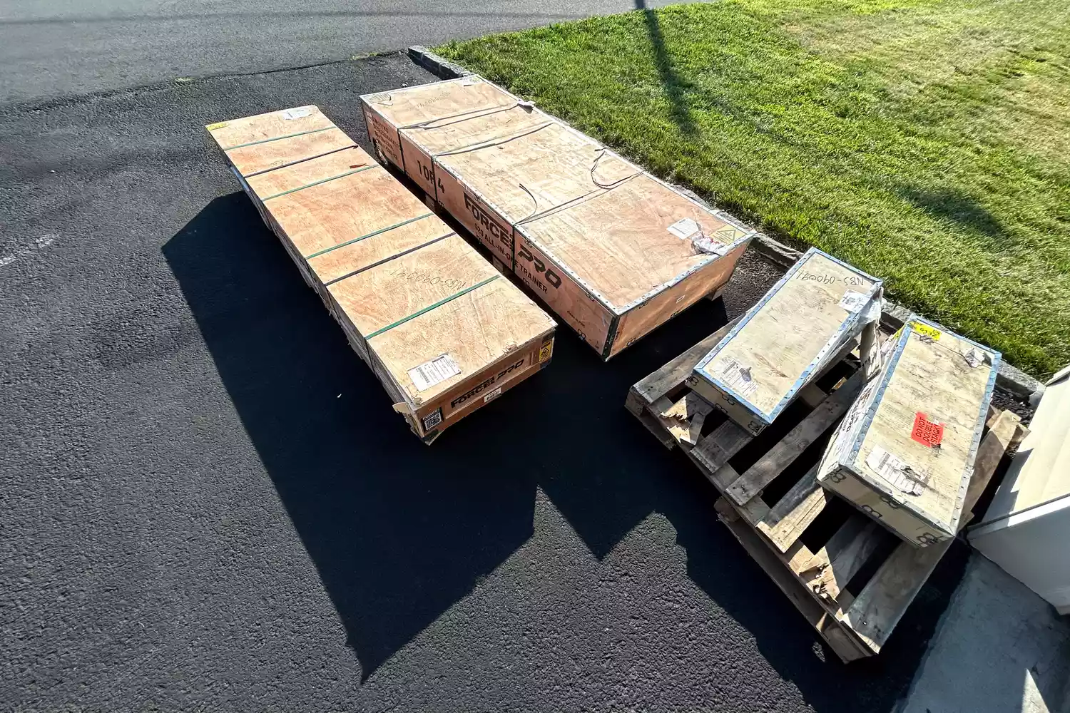 Packed pieces of the Force USA G20 Pro All-In-One Trainer in plywood packaging after delivery