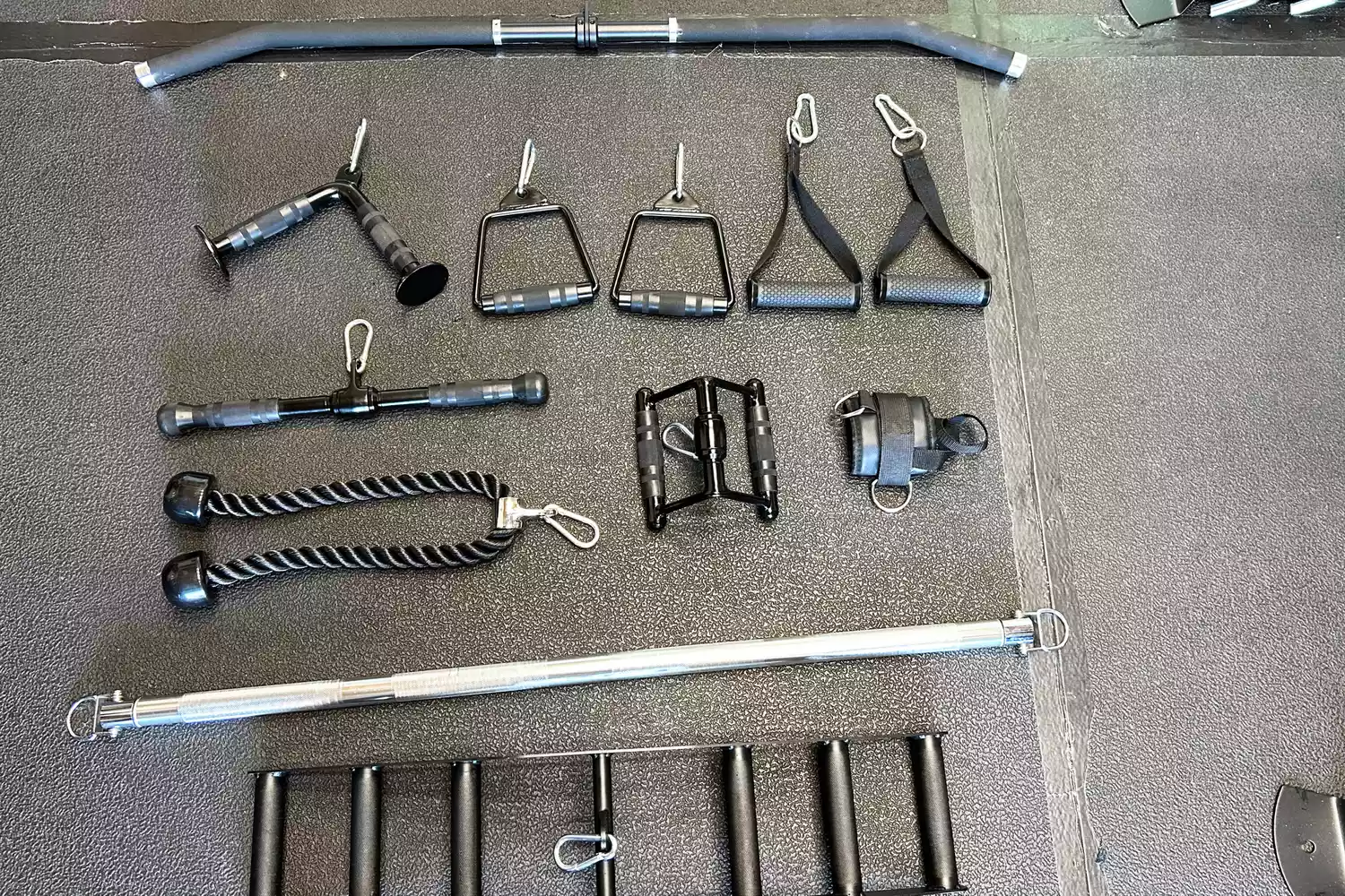 The Force USA G20 Pro All-In-One Trainer's varied lifting handle kit on a gym floor