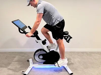 A side view of a person riding the Freebeat Boom Bike