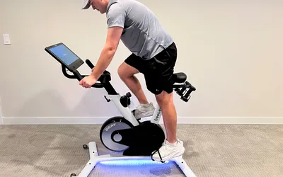 A side view of a person riding the Freebeat Boom Bike