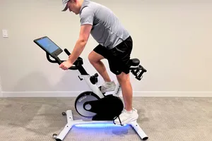 A side view of a person riding the Freebeat Boom Bike