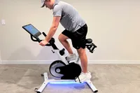 A side view of a person riding the Freebeat Boom Bike