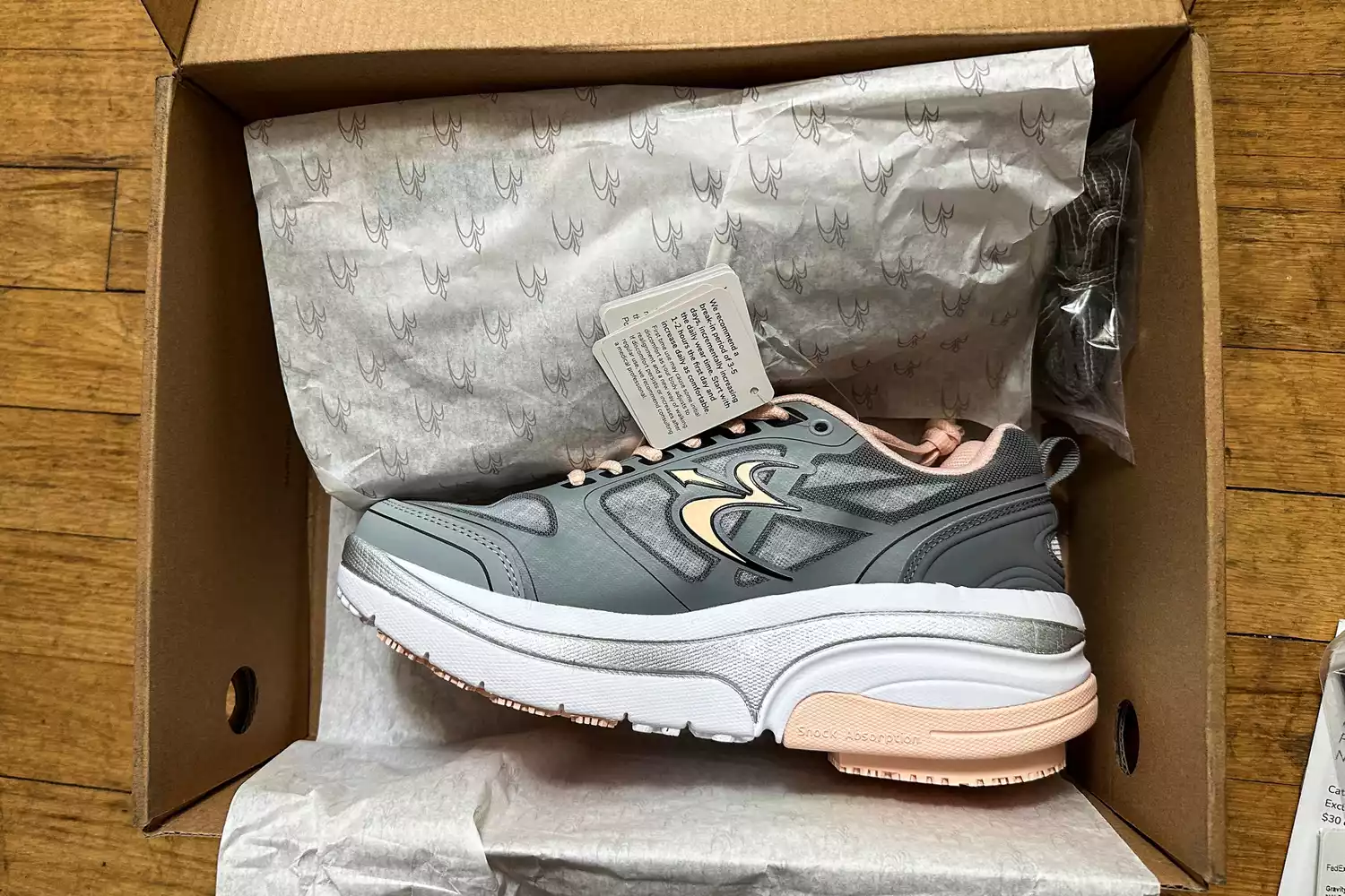 A pair of GDEFY Women's Ion Athletic Shoes in a shoebox with the tags on