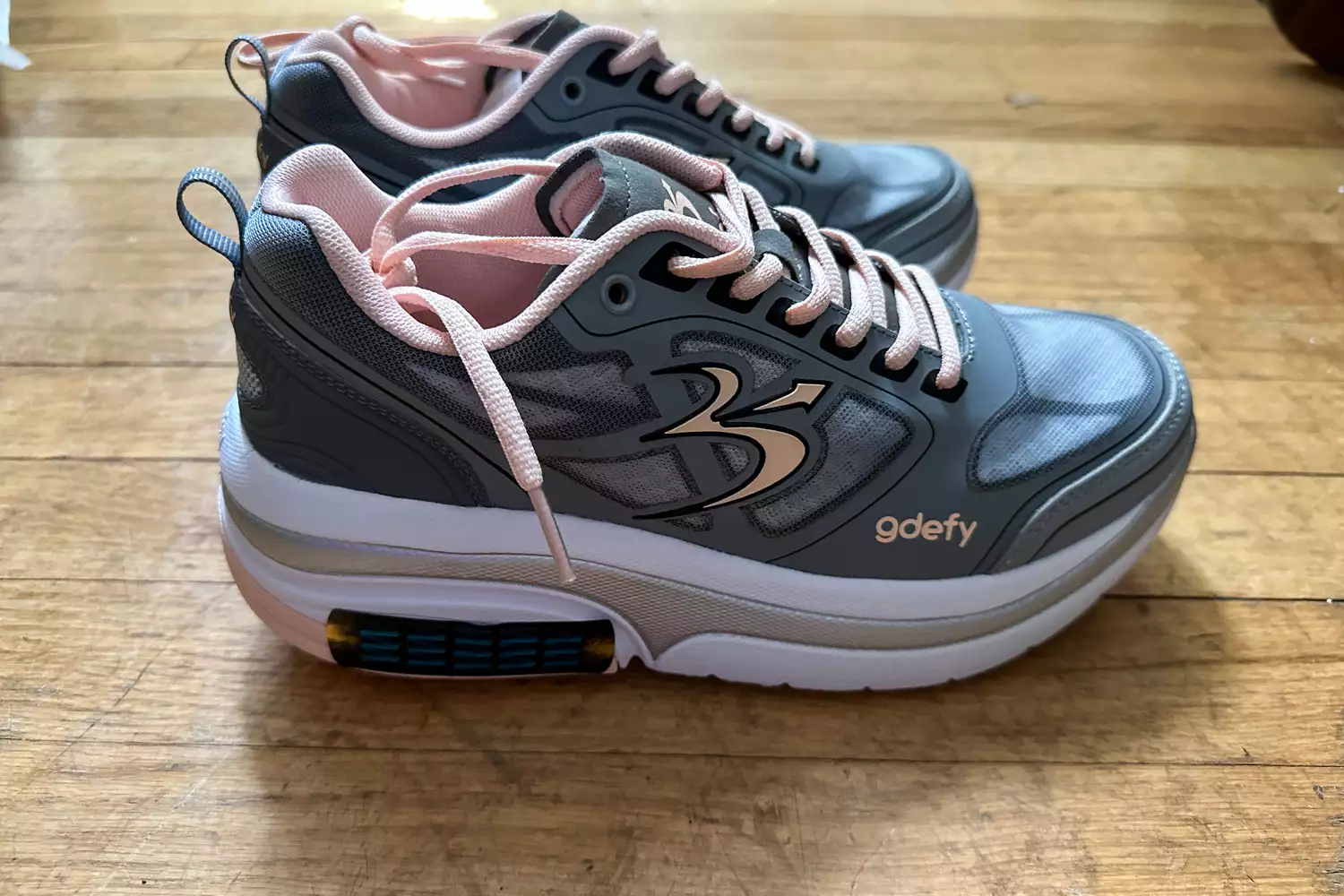 A side view of a pair of GDEFY Women's Ion Athletic Shoes