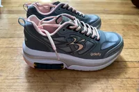 A side view of a pair of GDEFY Women's Ion Athletic Shoes