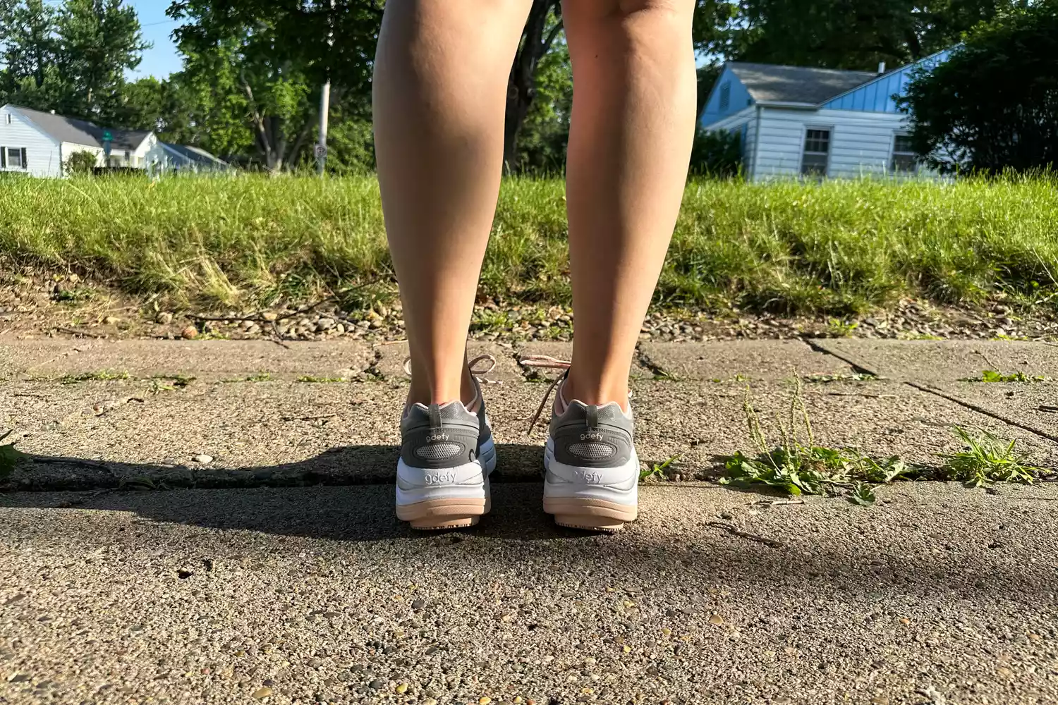 The back of a person wearing the GDEFY Women's Ion Athletic Shoes