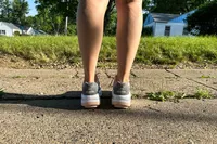 The back of a person wearing the GDEFY Women's Ion Athletic Shoes