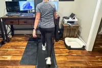 A person walks on the GoPlus folding treadmill 