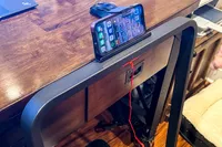 A phone inserted into the GoPlus 2 in 1 Folding Treadmill