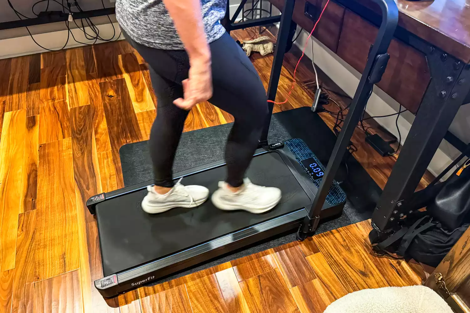 A person walks on the GoPlus 2 in 1 Folding Treadmill