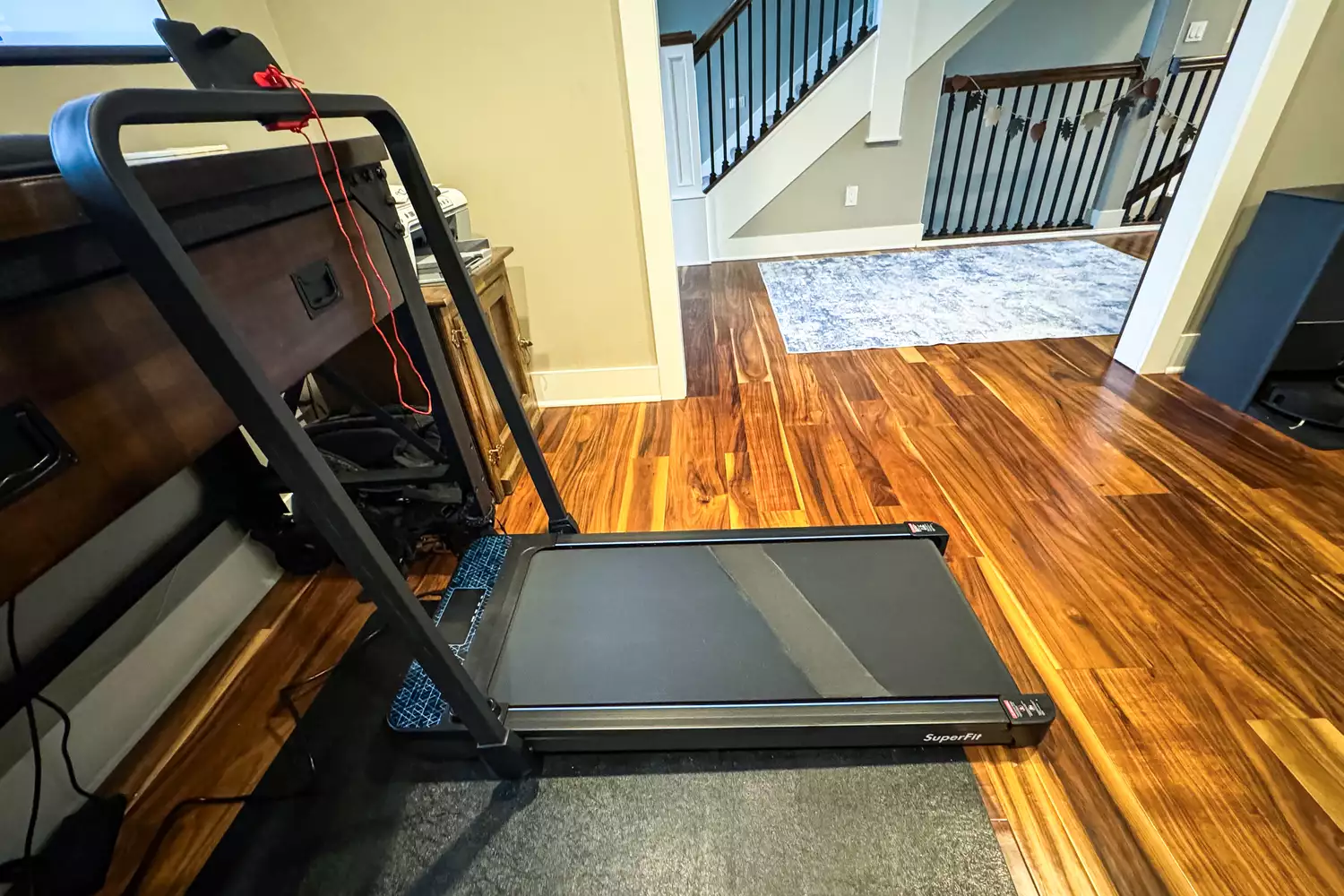 The GoPlus 2 in 1 Folding Treadmill on a wooden floor