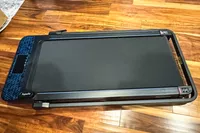 The GoPlus 2 in 1 Folding Treadmill folded on a wooden floor