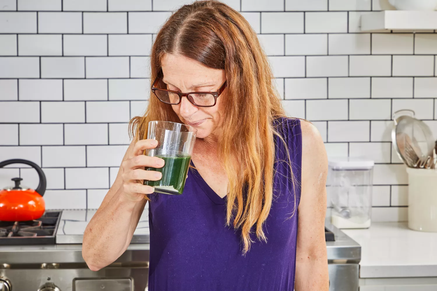 Person drinking a glass of BioSteel Powdered Greens Antioxidant Superfood