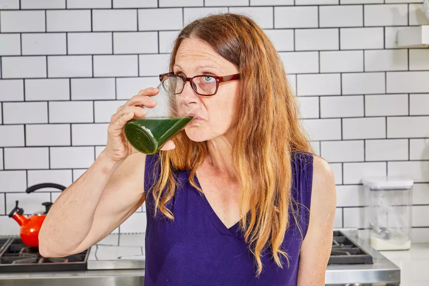 Person drinking glass of BioSteel Powdered Greens Antioxidant Superfood