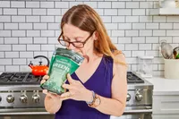 Person smelling Dr. Mercola Fermented Greens Powder