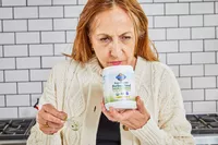 Person smelling Garden of Life Raw Organic Perfect Food Green Superfood