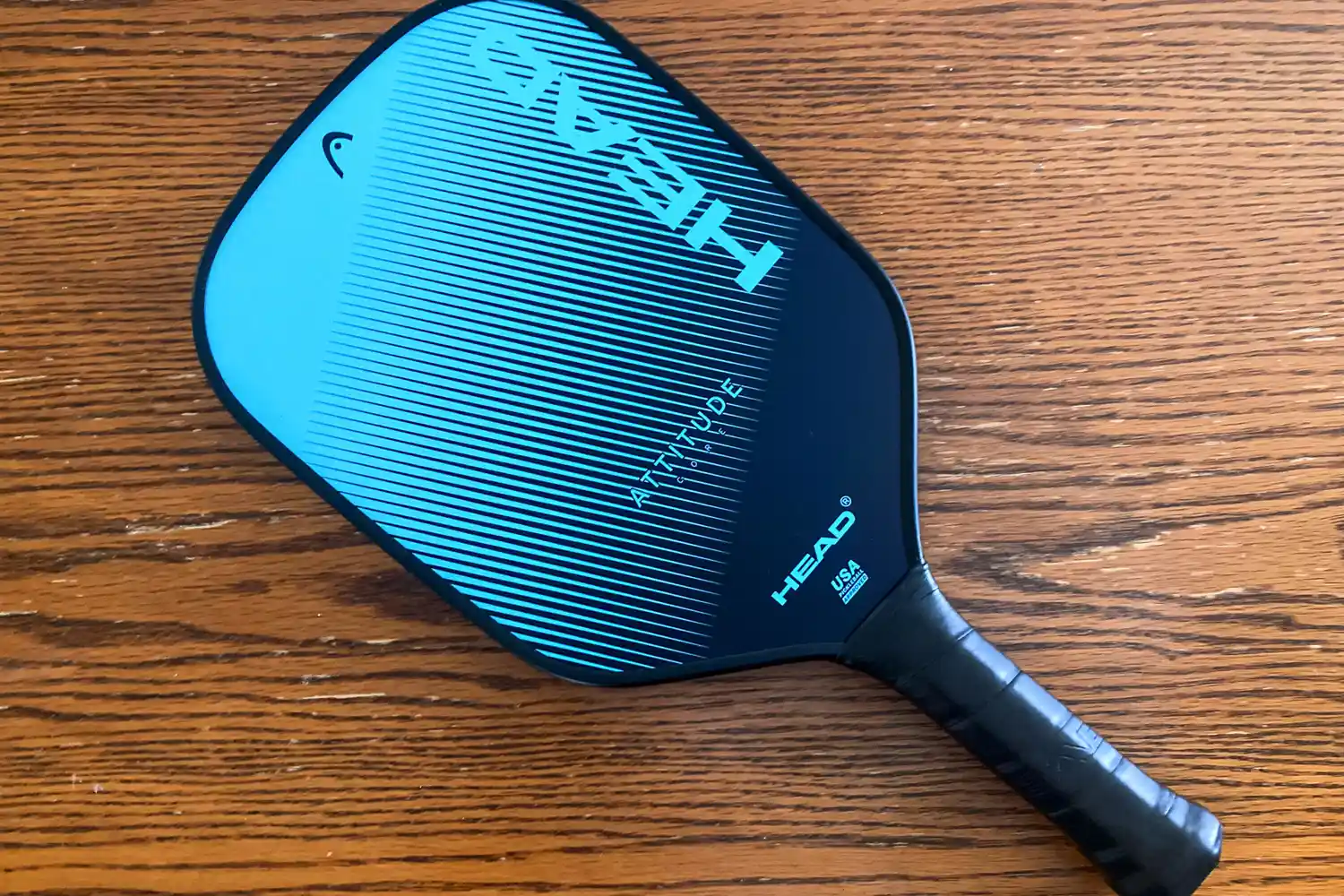 The HEAD Attitude Core Pickleball Paddle on a wooden table
