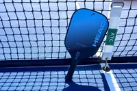 The HEAD Attitude Core Pickleball Paddle rests on a net