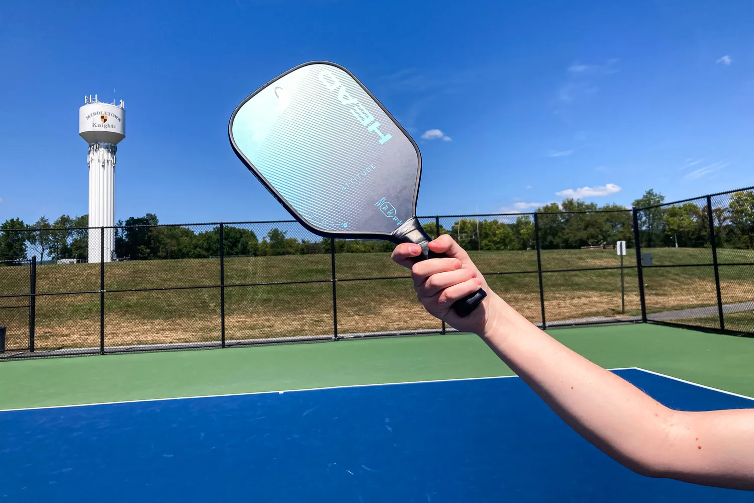 A person holds up the HEAD Attitude Core Pickleball Paddle