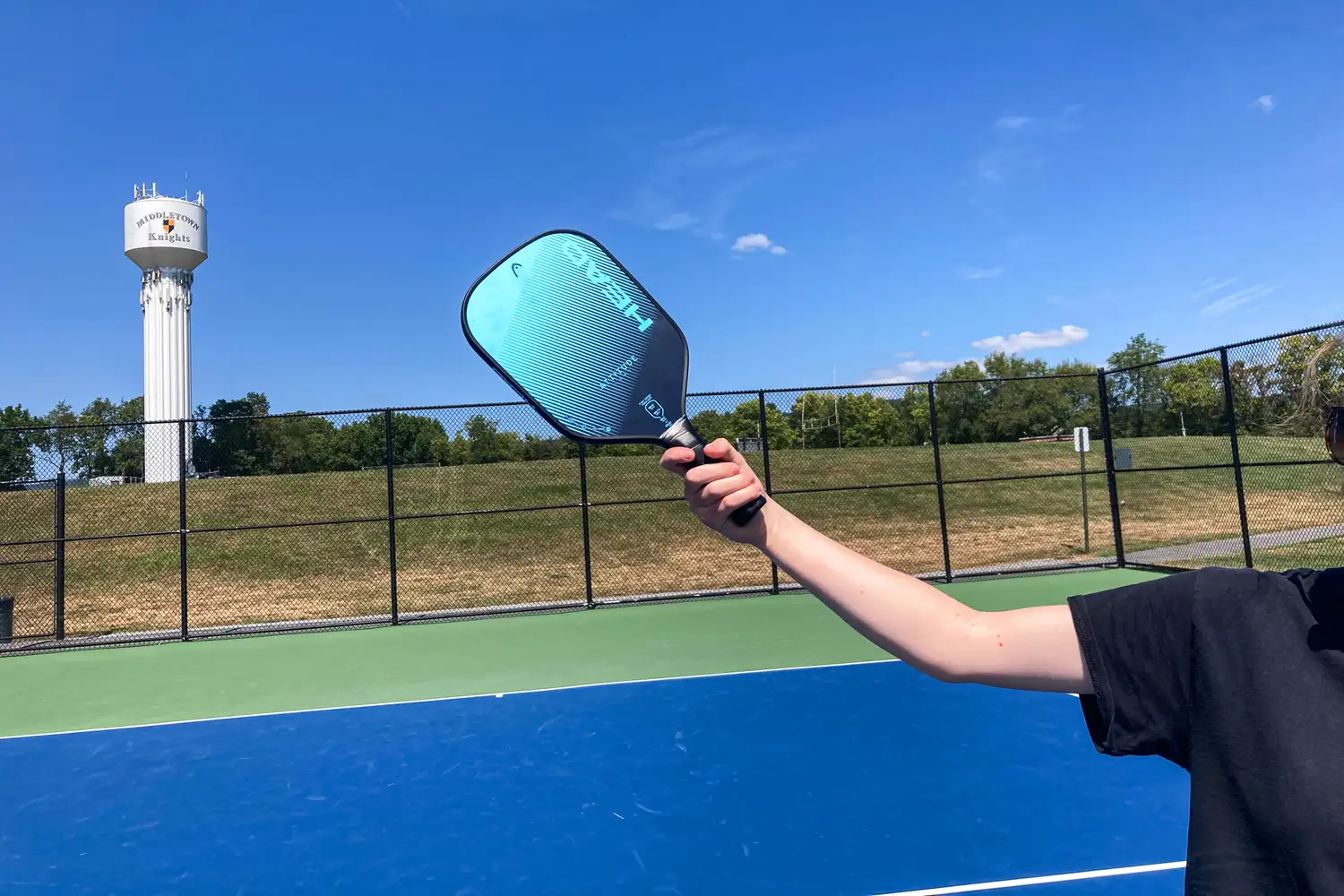 A person holds the HEAD Attitude Core Pickleball Paddle