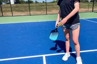 A person holds the HEAD Attitude Core Pickleball Paddle
