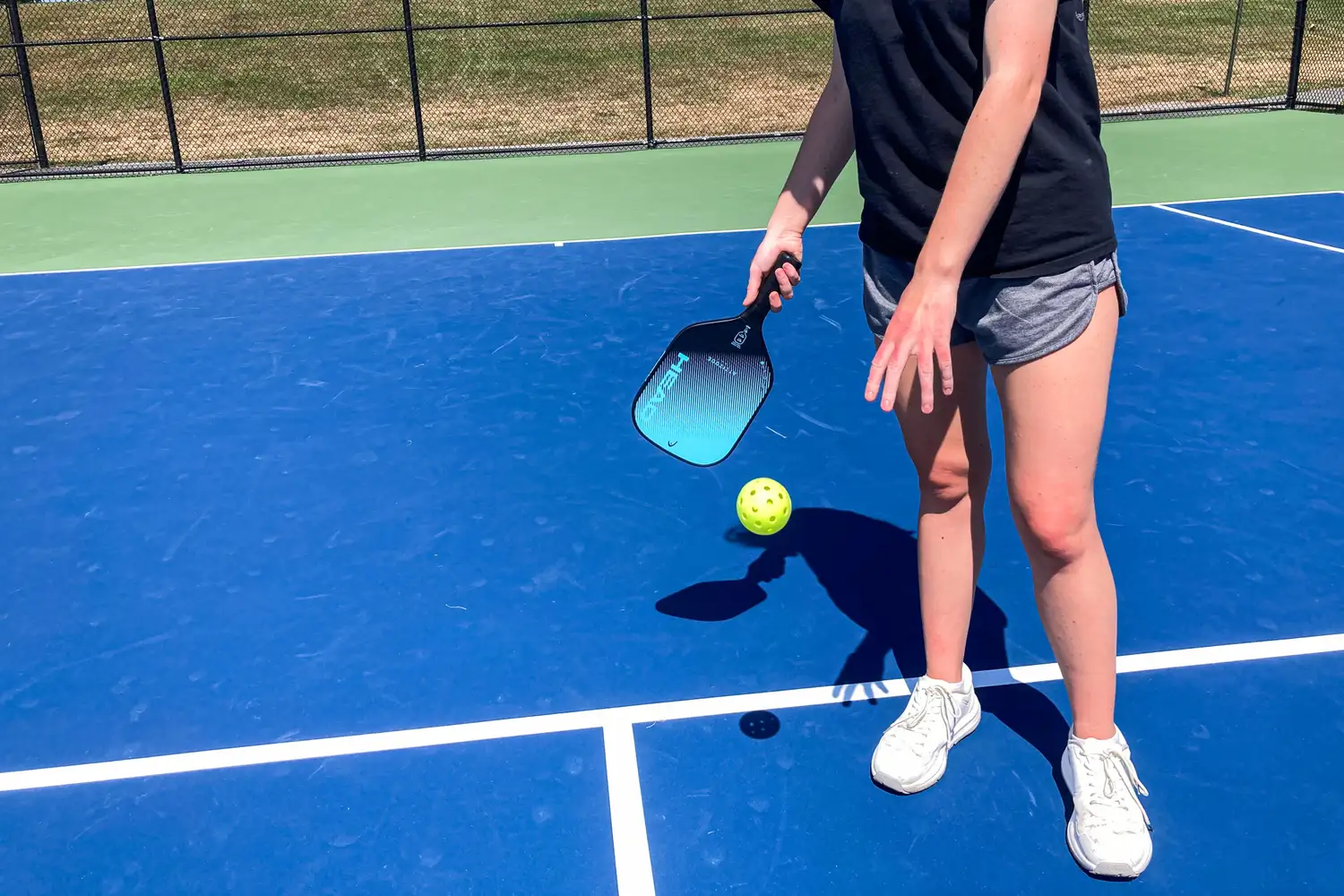 A person hits a pickleball with the HEAD Attitude Core Pickleball Paddle