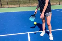 A person hits a pickleball with the HEAD Attitude Core Pickleball Paddle