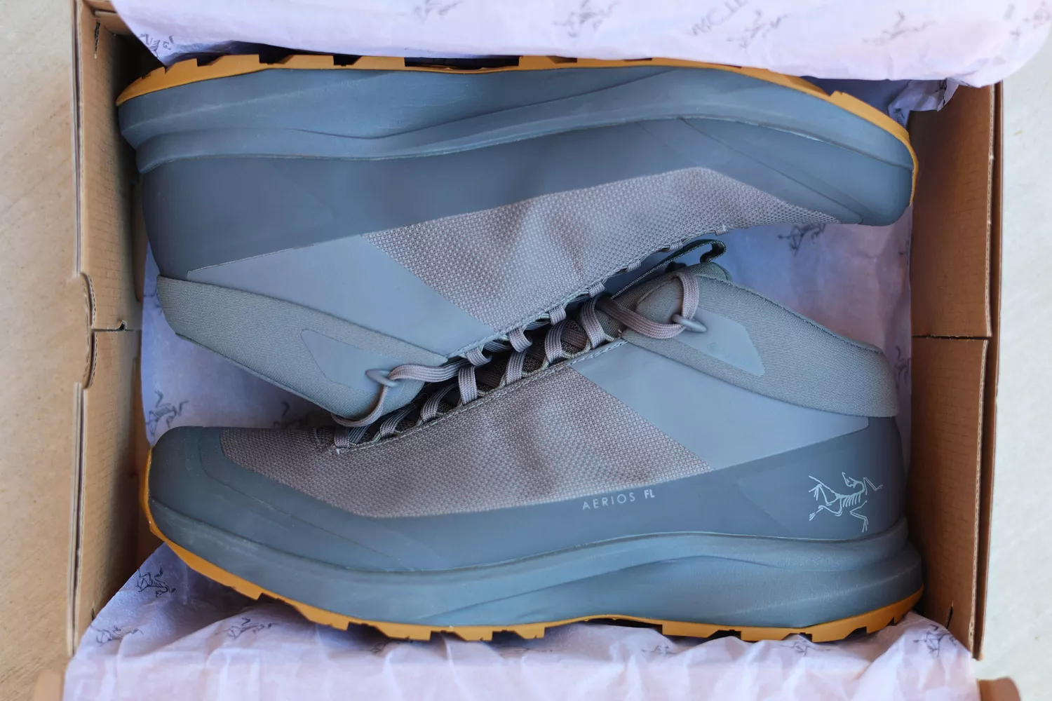 A new pair of Arc'teryx Aerios FL 2 Mid GTX Hiking Shoes inside a shoe box