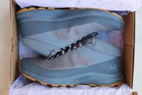 A new pair of Arc'teryx Aerios FL 2 Mid GTX Hiking Shoes inside a shoe box
