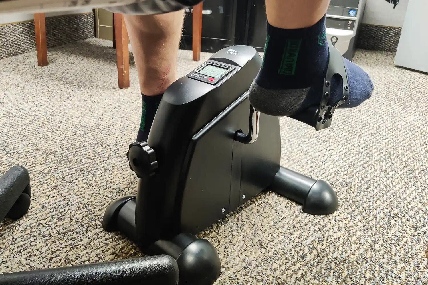 A person pedals the Himaly Mini Exercise Bike