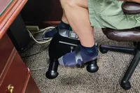 A person pedals the Himaly Mini Exercise Bike 