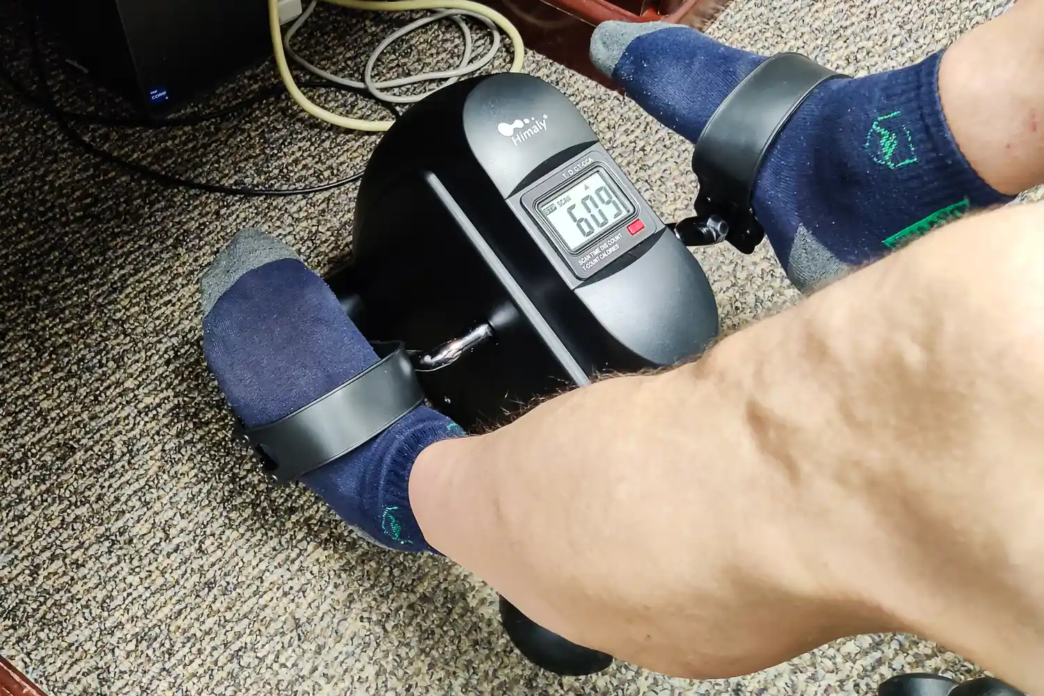 A person pedals the Himaly Mini Exercise Bike