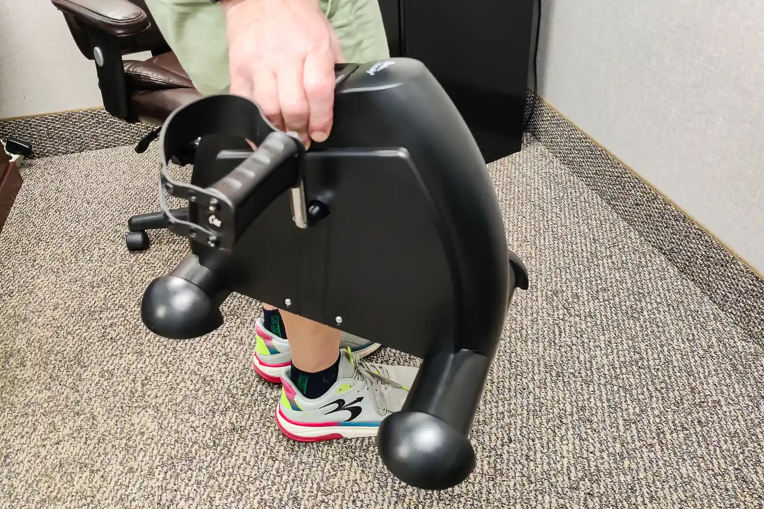 A person lifts the Himaly Mini Exercise Bike