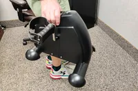 A person lifts the Himaly Mini Exercise Bike