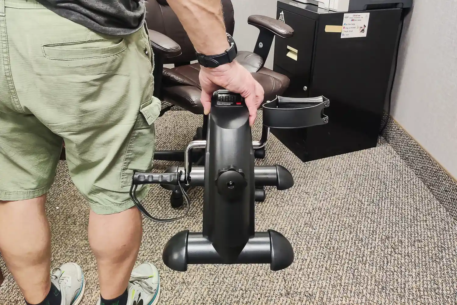 A person holds up the Himaly Mini Exercise Bike