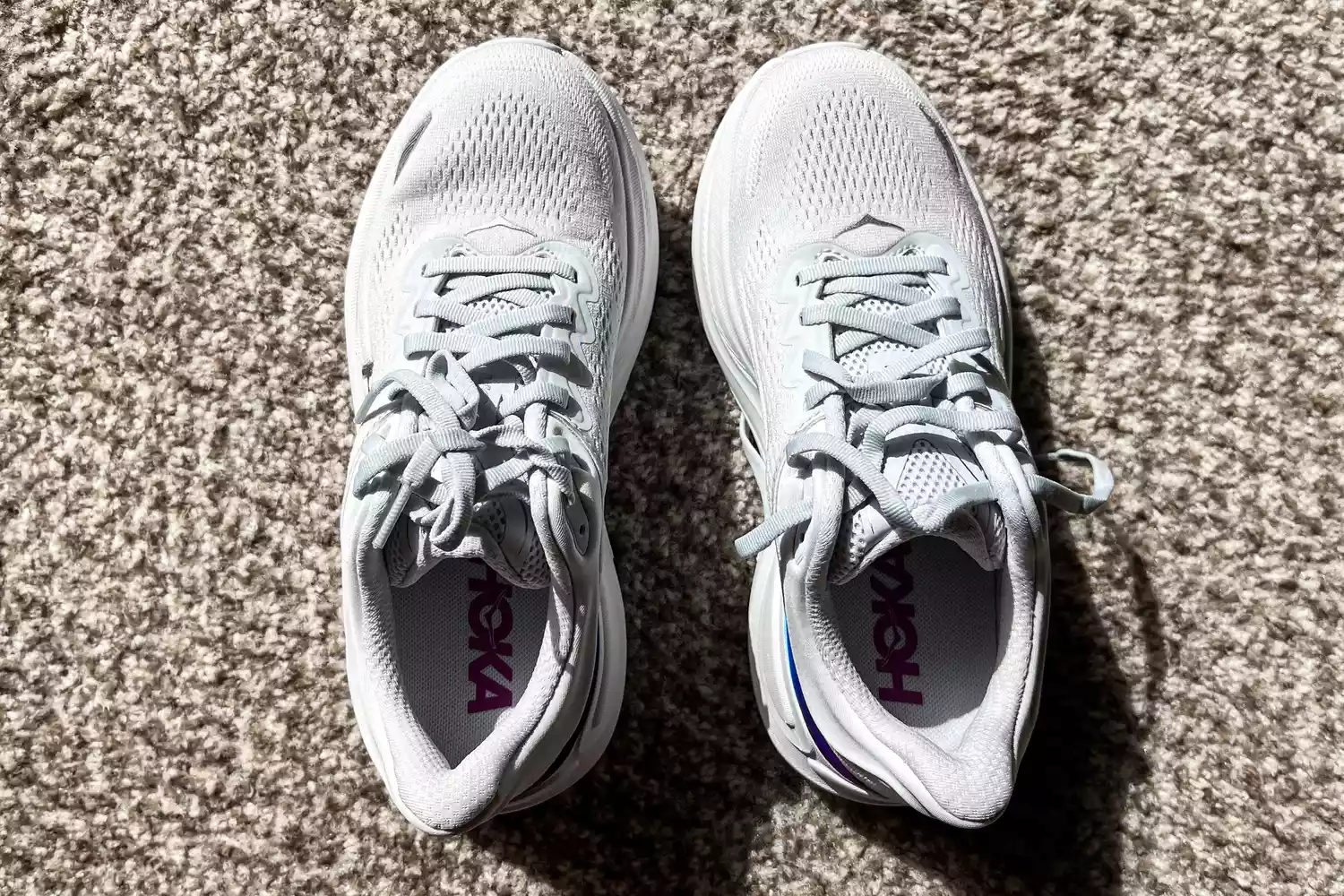 An overhead view of the Hoka Women's Bondi 9 sneakers on a carpet