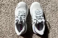An overhead view of the Hoka Women's Bondi 9 sneakers on a carpet