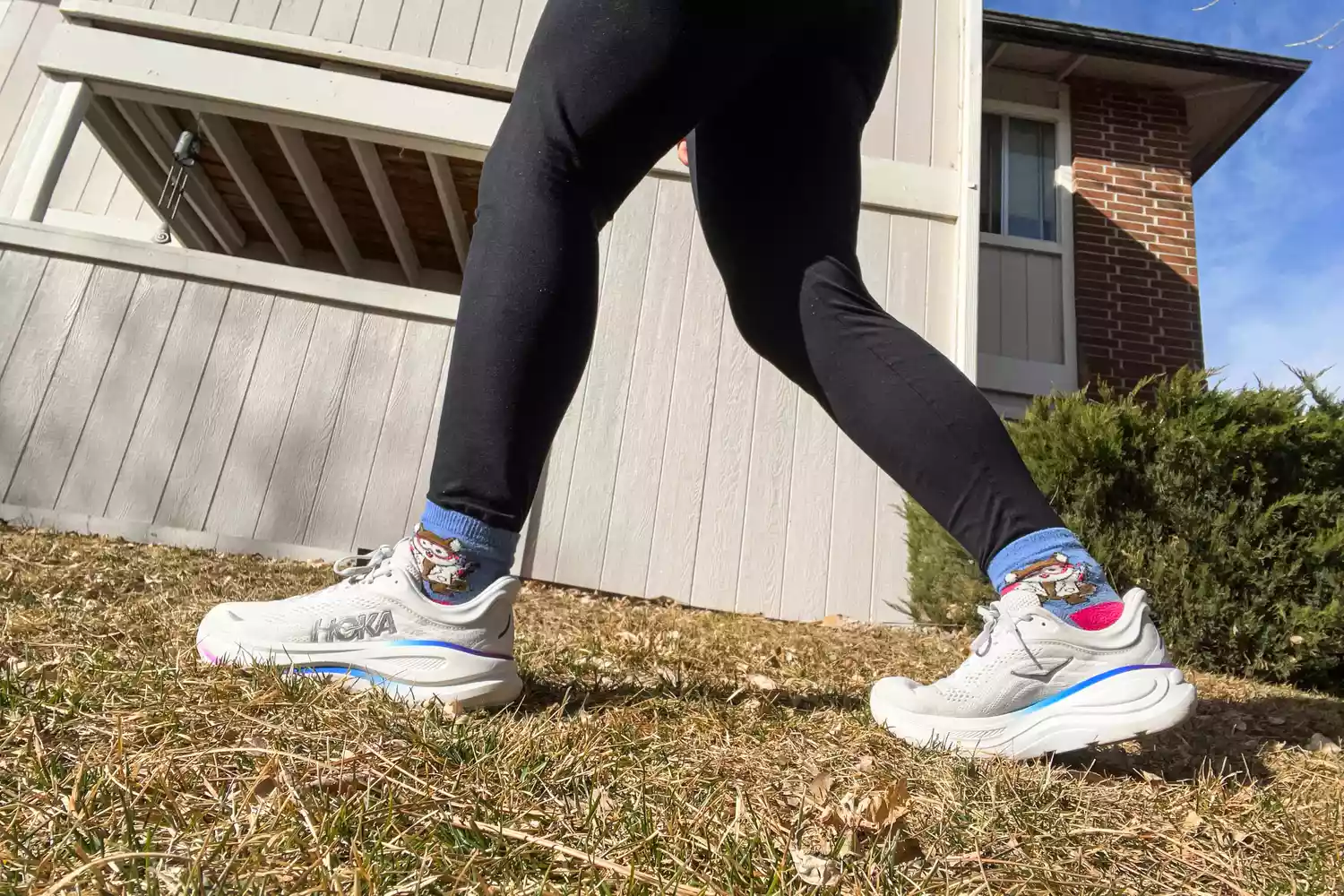 A side view of a person wearing the Hoka Women's Bondi 9