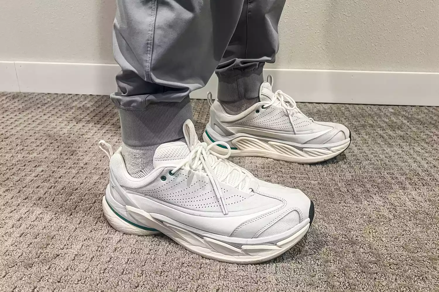 A person wears the Hoka All Gender Elevon X Running Shoes inside