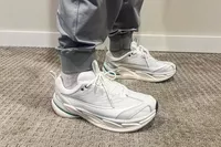 A person wears the Hoka All Gender Elevon X Running Shoes inside