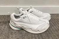 A pair of Hoka All Gender Elevon X Running Shoes on carpet